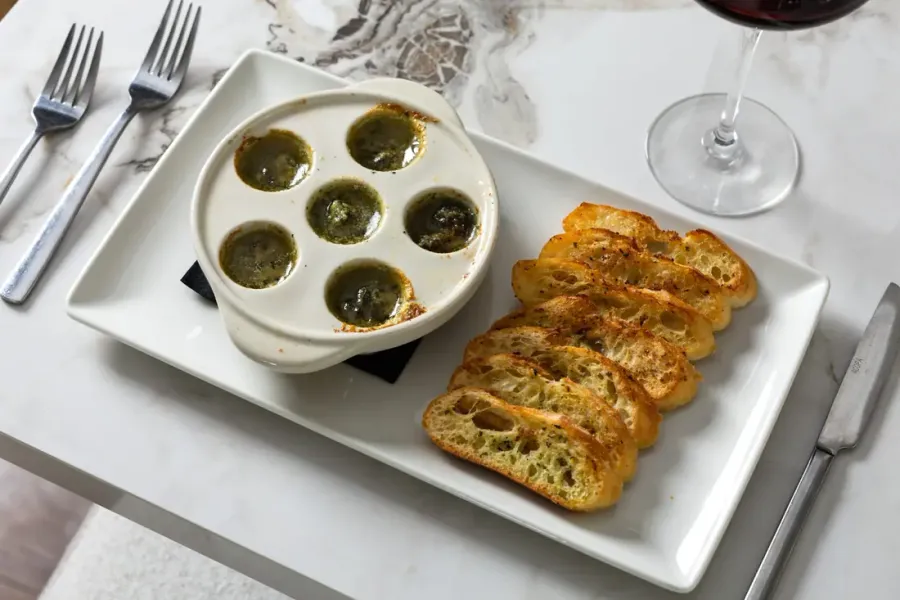 A plate of escargots with toasted bread