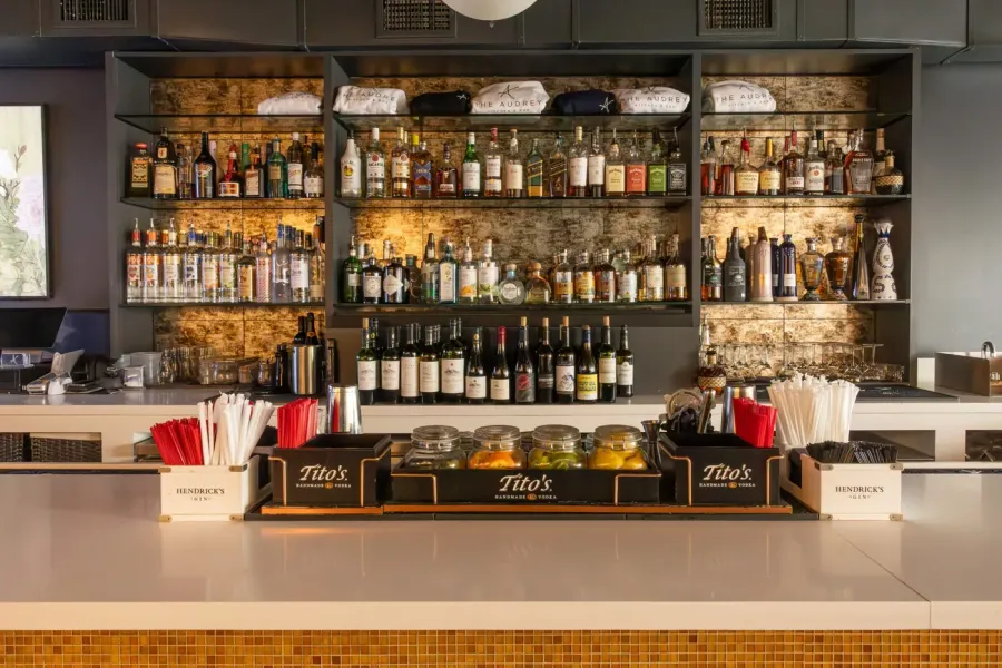 The back bar at The Audrey, stocked and lit