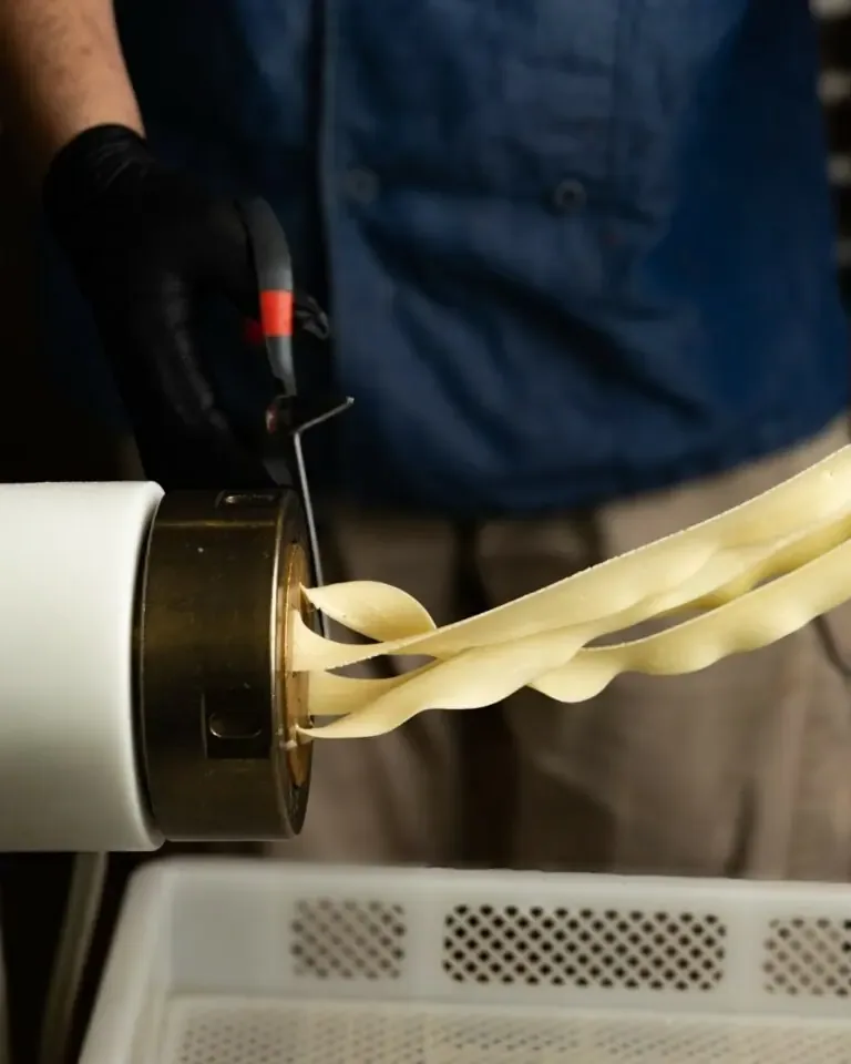 Pasta being rolled by hand in one of the group's kitchens
